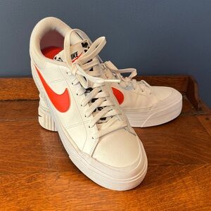 Nike Court Legacy Lift White Platform Sneakers with Bold Orange Swoosh